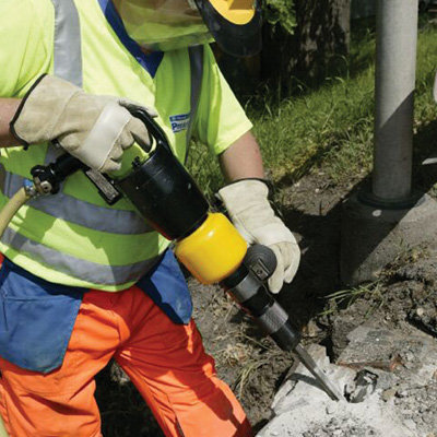 An Air Pick Light Duty - Low Vibration being operated on a concrete.